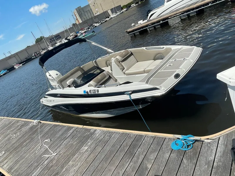 Slide: The Image of 2020 Crownline E 205 XS boat docked at marina on sunny day. - 8