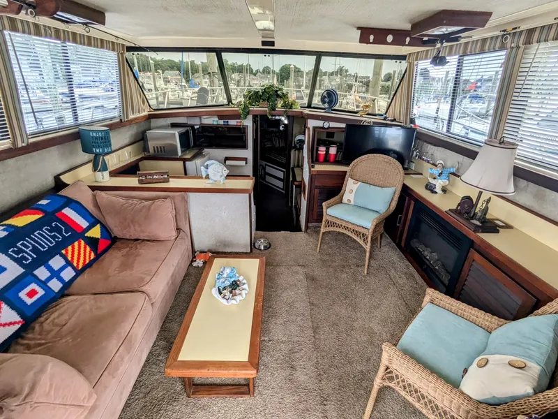 Slide: The Image of Interior of 1981 Silverton 37 Convertible yacht with cozy seating and nautical decor. - 15
