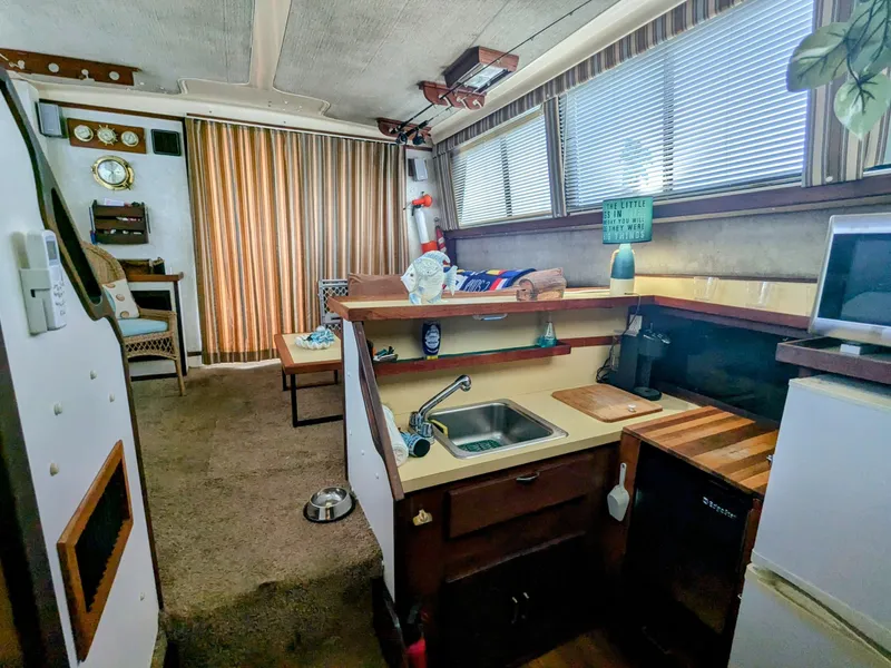 Slide: The Image of Interior of 1981 Silverton 37 Convertible boat with kitchen and seating area. - 18