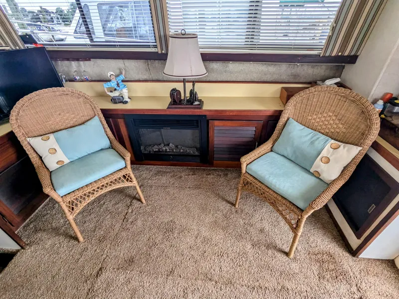 Slide: The Image of Interior of 1981 Silverton 37 Convertible with wicker chairs and cozy decor. - 19