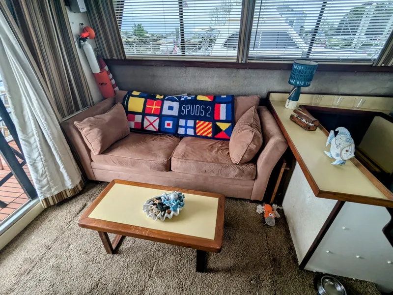 Slide: The Image of Interior of 1981 Silverton 37 Convertible with cozy sofa and nautical decor. - 21