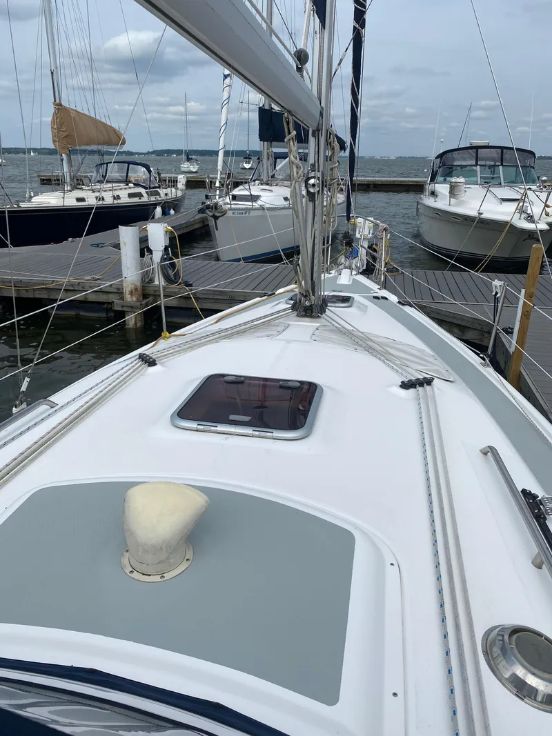 Slide: The Image of Sailboat docked at marina, Hunter 33 model, 2008, with visible deck and rigging. - 12