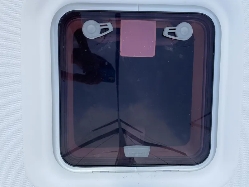 Slide: The Image of Hatch window on a 2008 Hunter 33 sailboat, featuring secure latches. - 24