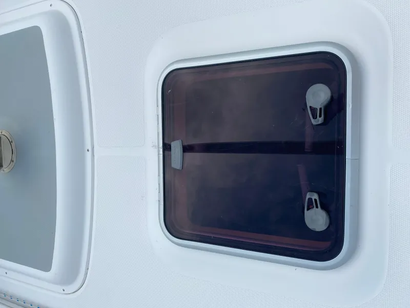 Slide: The Image of Hatch on 2008 Hunter 33 sailboat deck, featuring secure latches and sleek design. - 29