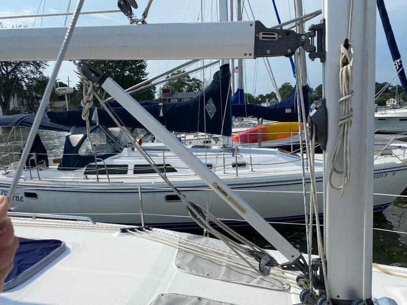 Slide: The Image of 2008 Hunter 33 sailboat docked in marina, surrounded by other boats. - 31