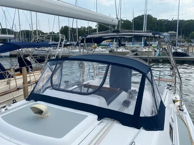 Slide: The Image of 2008 Hunter 33 sailboat docked at marina with blue canvas cover. - 33