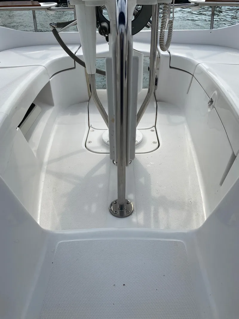 Slide: The Image of Cockpit of 2008 Hunter 33 sailboat with clean white deck and steering wheel. - 36