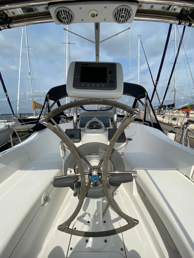Slide: The Image of Cockpit view of a 2008 Hunter 33 sailboat with steering wheel and navigation equipment. - 37