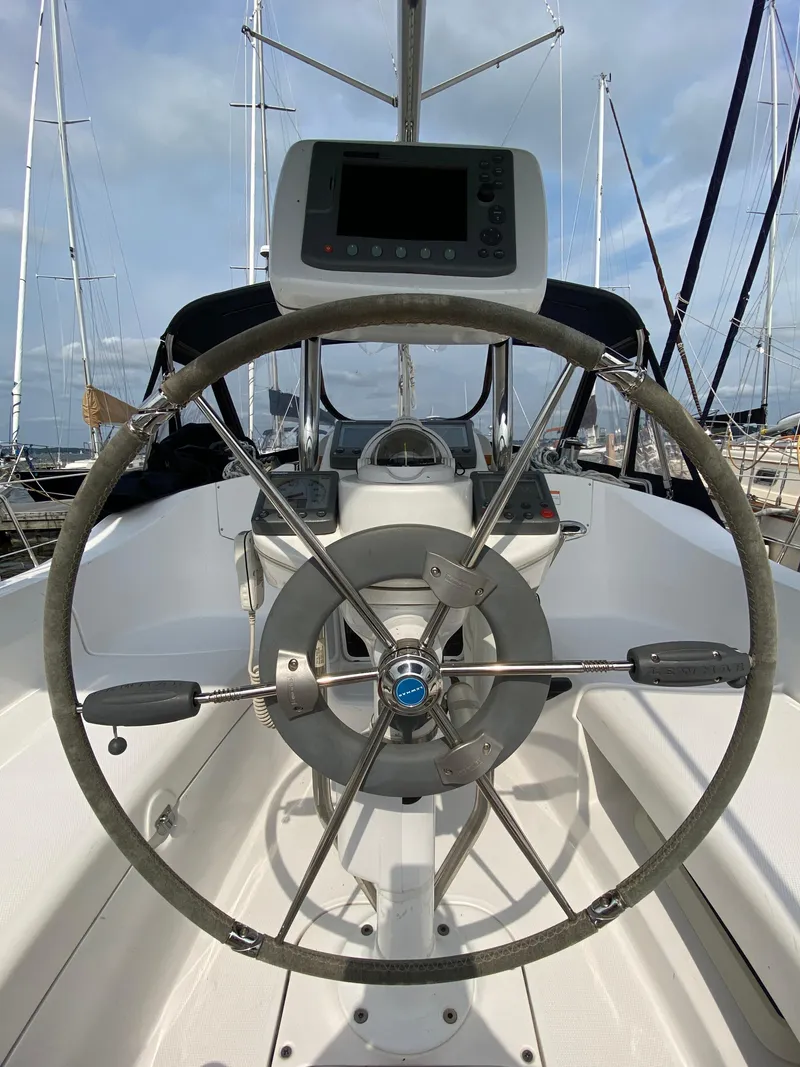 Slide: The Image of Steering wheel of a 2008 Hunter 33 sailboat, docked in a marina. - 38