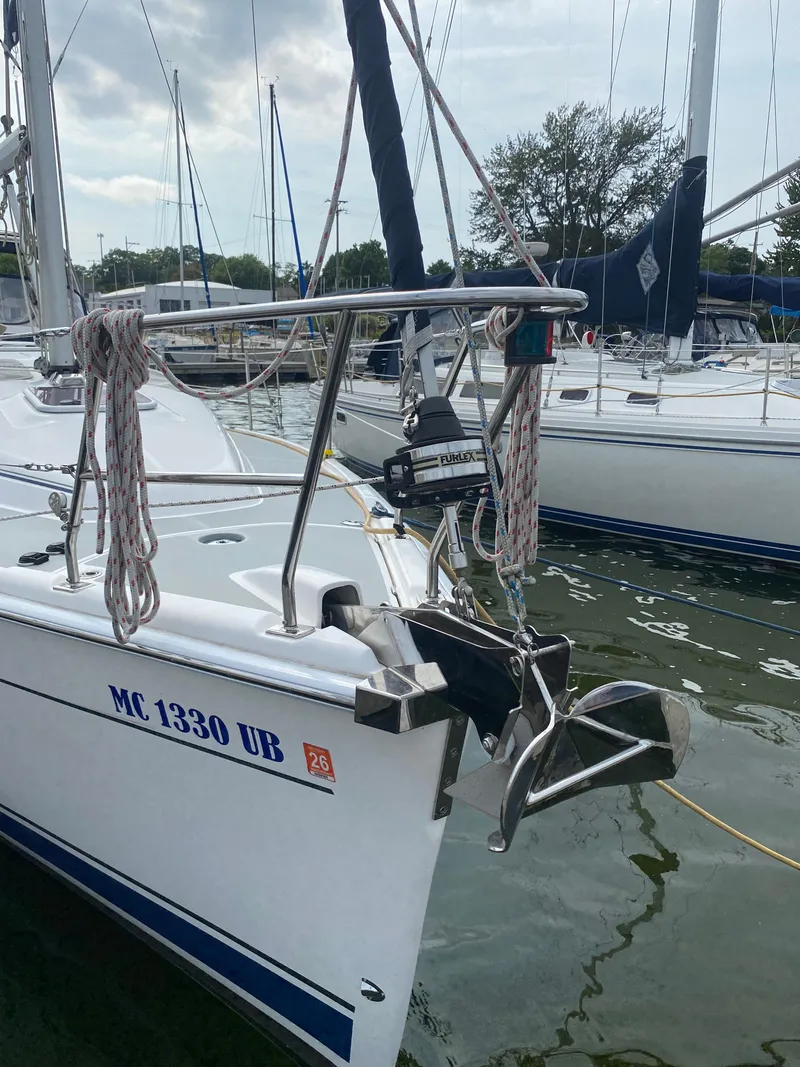 Slide: The Image of 2008 Hunter 33 sailboat docked, featuring anchor and ropes. - 4