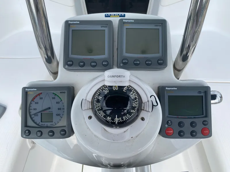 Slide: The Image of Control panel of a 2008 Hunter 33 sailboat with Raymarine instruments and compass. - 41
