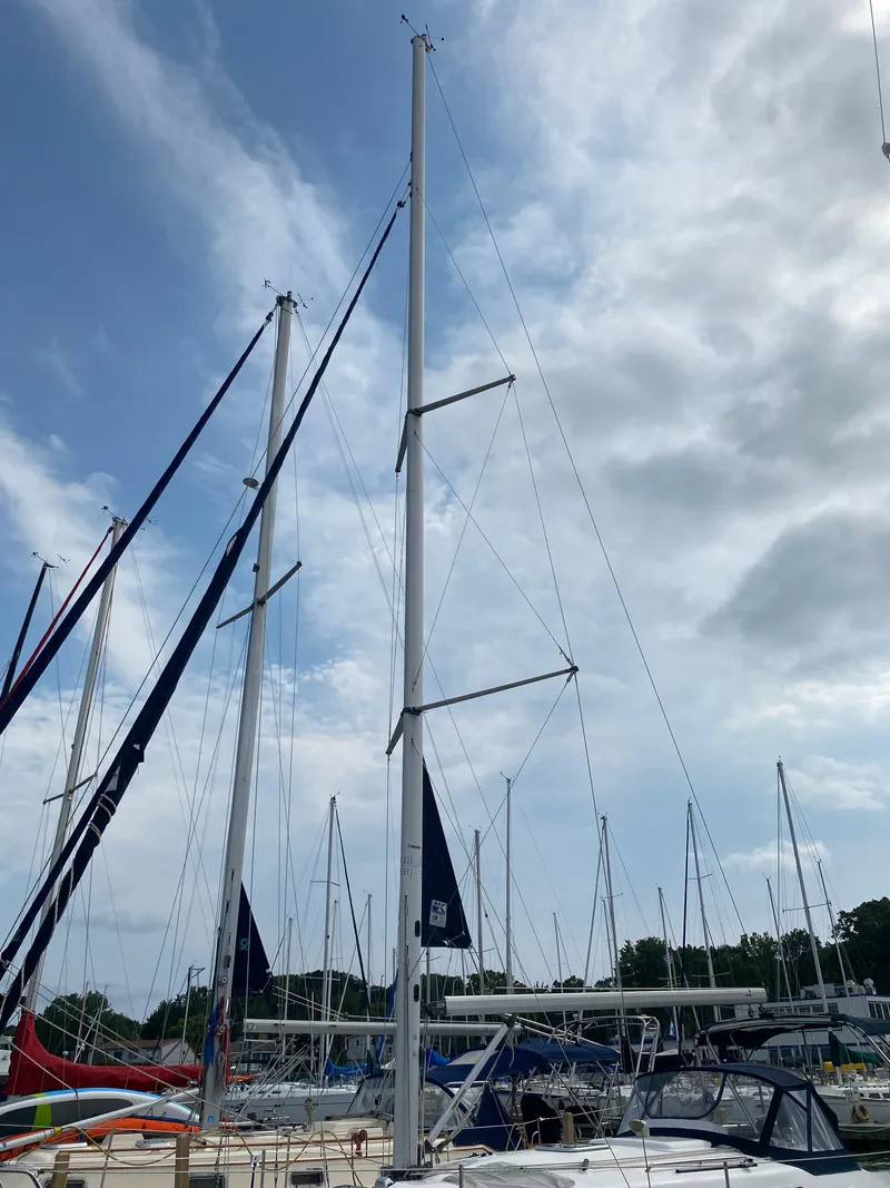 Slide: The Image of Sailboats docked at a marina under a cloudy sky, featuring a 2008 Hunter 33. - 7