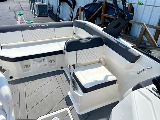 Slide: The Image of 2021 Bayliner DX 2250 boat interior with white seating and modern design. - 10