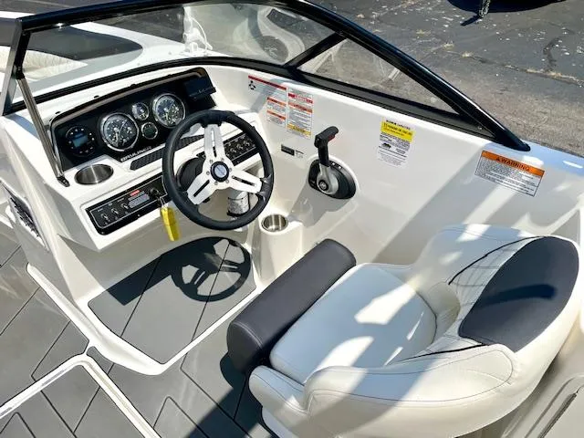 Slide: The Image of 2021 Bayliner DX 2250 boat cockpit with steering wheel and control panel. - 12