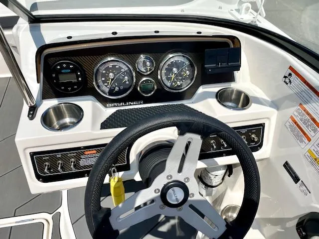Slide: The Image of Cockpit of 2021 Bayliner DX 2250 boat with steering wheel and instrument panel. - 15