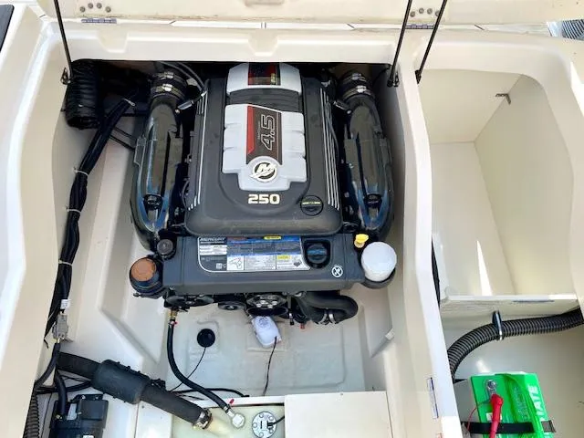 Slide: The Image of Engine compartment of a 2021 Bayliner DX 2250 boat, featuring a 4.5L 250 HP engine. - 19
