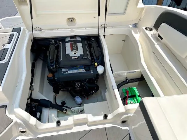 Slide: The Image of Engine compartment of a 2021 Bayliner DX 2250 boat, showcasing the engine and battery. - 20