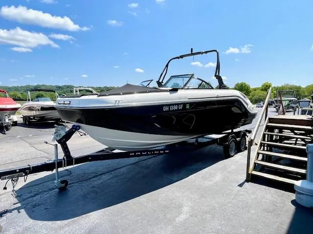 Slide: The Image of 2021 Bayliner DX 2250 boat on trailer under clear blue sky. - 4