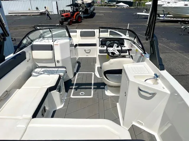 Slide: The Image of 2021 Bayliner DX 2250 boat interior with seating, steering wheel, and deck layout. - 8