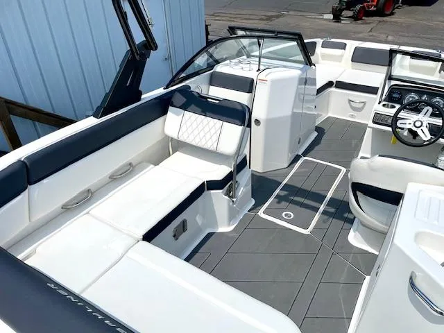 Slide: The Image of 2021 Bayliner DX 2250 boat interior with modern seating and dashboard design. - 9