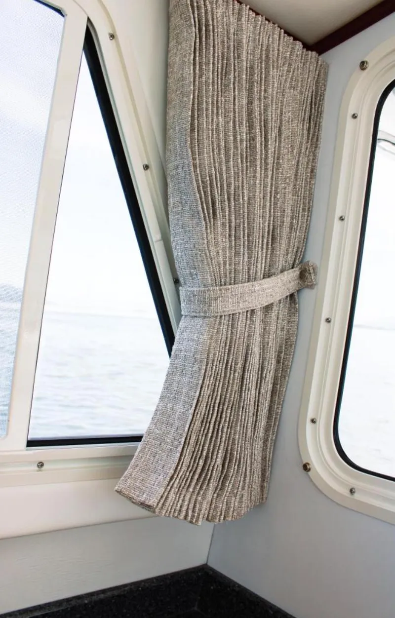 Slide: The Image of Interior view of 2022 Ocean Sport 30 Roamer #124 with window and curtain. - 13