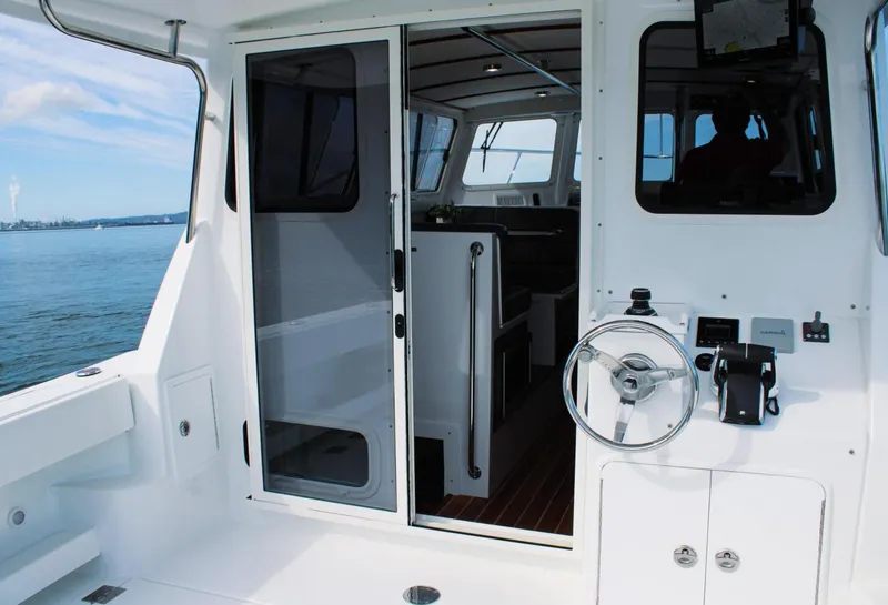 Slide: The Image of Interior view of 2022 Ocean Sport 30 Roamer boat with open cabin door. - 14