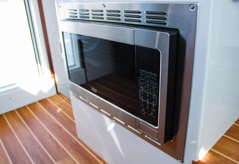 Slide: The Image of Built-in microwave on Ocean Sport 30 Roamer 2022, featuring sleek stainless steel design. - 17