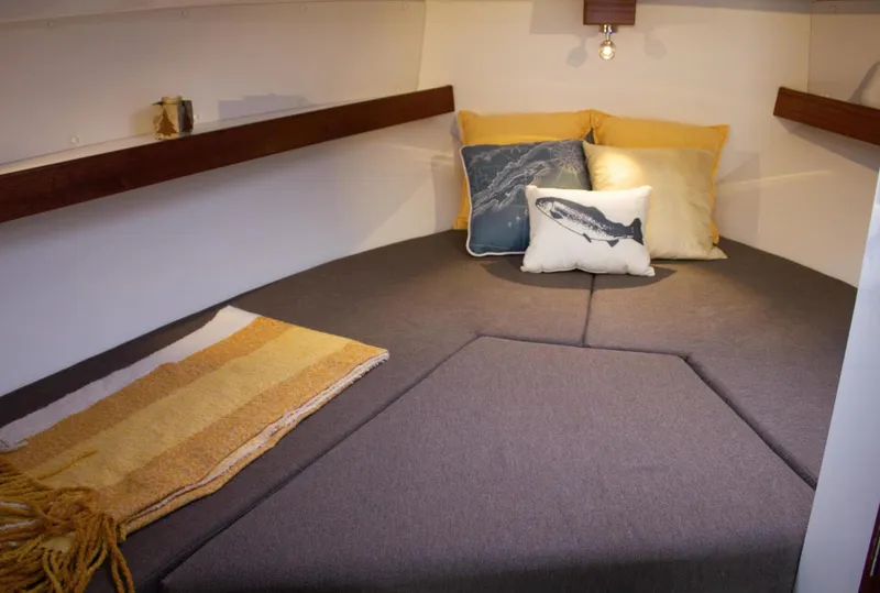 Slide: The Image of Cozy cabin interior of 2022 Ocean Sport 30 Roamer with cushions and blanket. - 19
