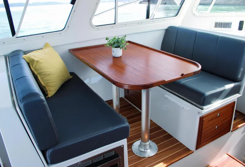 Slide: The Image of Luxurious interior of 2022 Ocean Sport 30 Roamer, featuring elegant seating and wooden table. - 4
