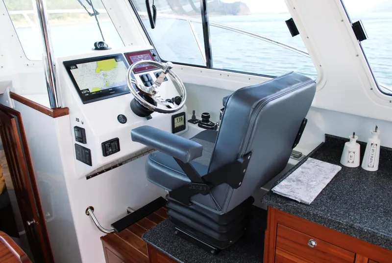 Slide: The Image of Interior of 2022 Ocean Sport 30 Roamer #124, featuring helm with navigation equipment. - 5