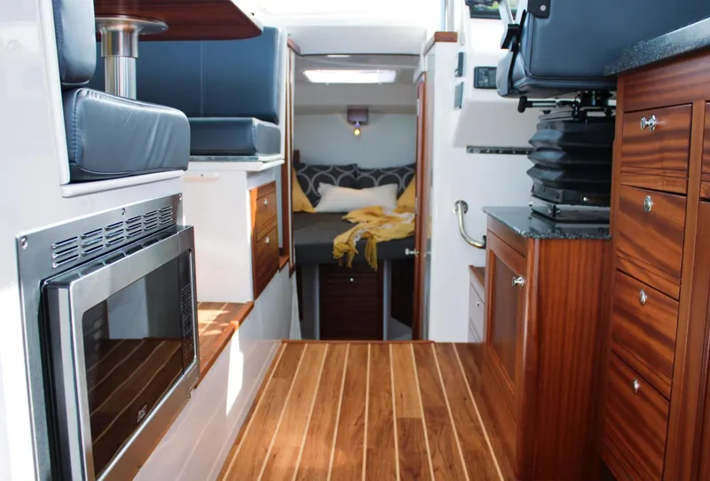 Slide: The Image of Interior of 2022 Ocean Sport 30 Roamer, featuring wood flooring and modern amenities. - 6