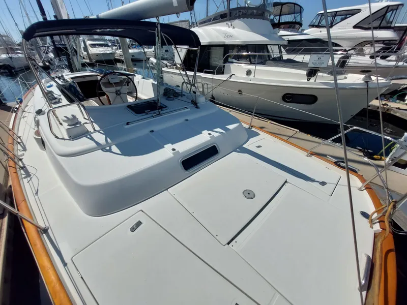 Slide: The Image of 2002 Beneteau Oceanis 42CC sailboat docked in marina, showcasing spacious deck and cockpit. - 13