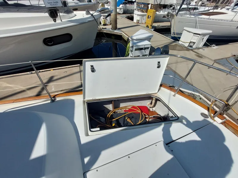 Slide: The Image of Open storage compartment on 2002 Beneteau Oceanis 42CC sailboat deck at marina. - 15