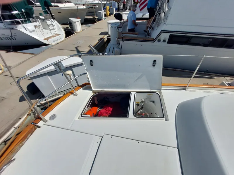 Slide: The Image of Beneteau Oceanis 42CC 2002 yacht deck with open storage compartments at marina. - 16