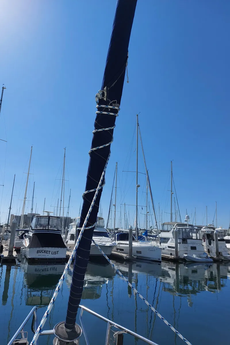 Slide: The Image of Beneteau Oceanis 42CC sailboat docked in a marina, clear blue sky, 2002 model. - 29