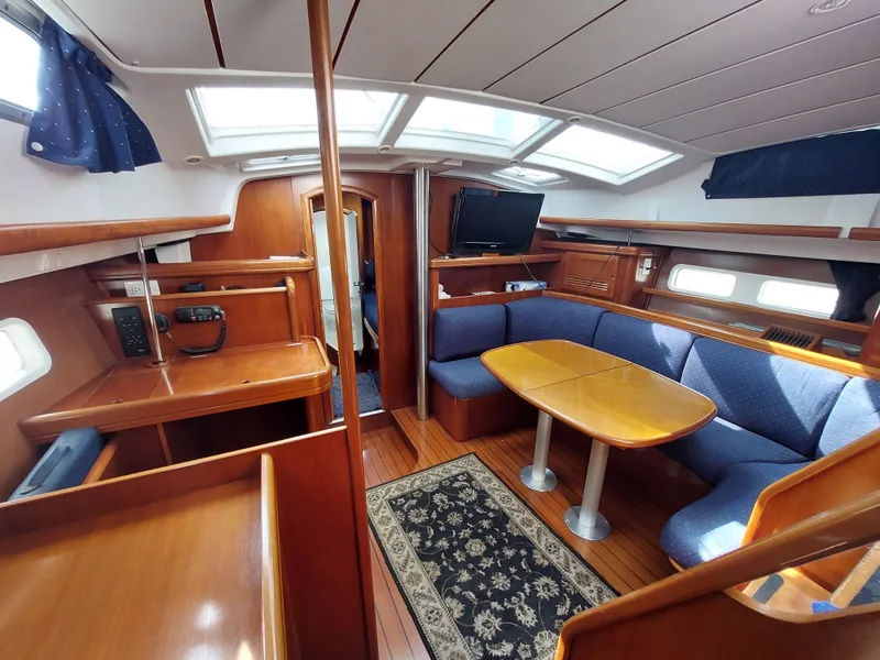 Slide: The Image of Interior of 2002 Beneteau Oceanis 42CC sailboat with wood finish and cozy seating area. - 31