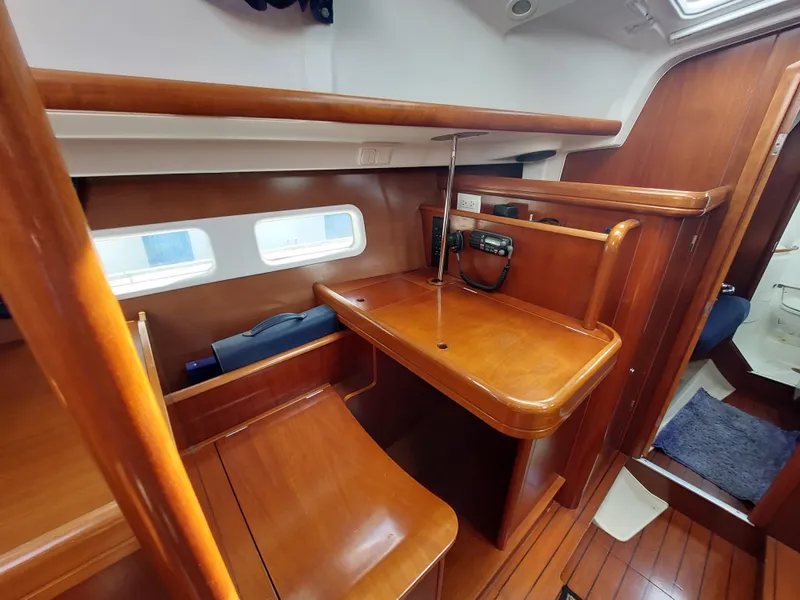 Slide: The Image of Beneteau Oceanis 42CC 2002 yacht interior with wooden desk and seating area. - 32
