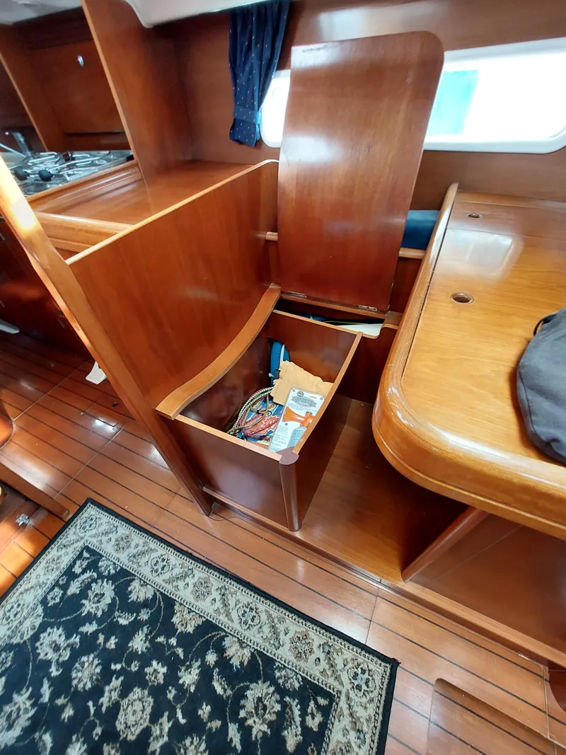Slide: The Image of Interior of 2002 Beneteau Oceanis 42CC sailboat with wooden cabinetry and storage. - 33