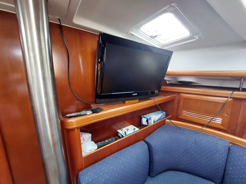 Slide: The Image of Beneteau Oceanis 42CC 2002 yacht interior with TV and wooden cabinetry. - 35