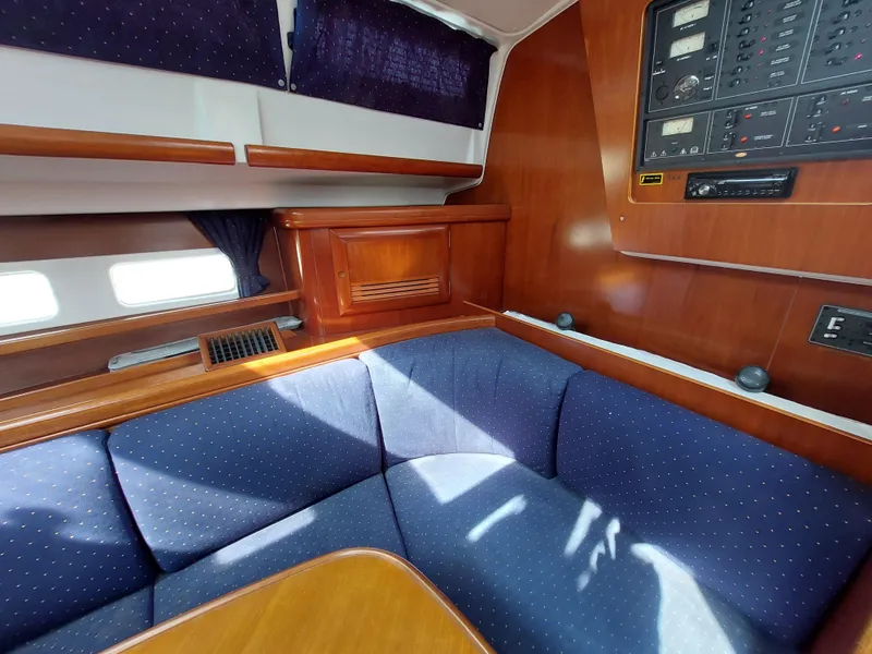 Slide: The Image of Interior of 2002 Beneteau Oceanis 42CC yacht with blue seating and wooden cabinetry. - 37