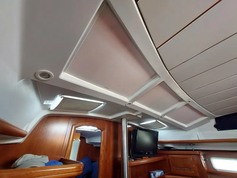 Slide: The Image of Interior of 2002 Beneteau Oceanis 42CC sailboat, featuring wood paneling and modern amenities. - 40