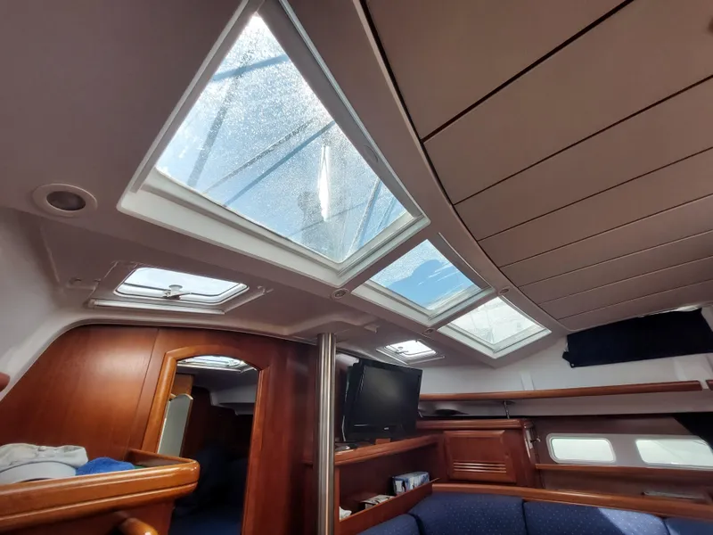 Slide: The Image of Interior of 2002 Beneteau Oceanis 42CC sailboat with skylights and wooden furnishings. - 41