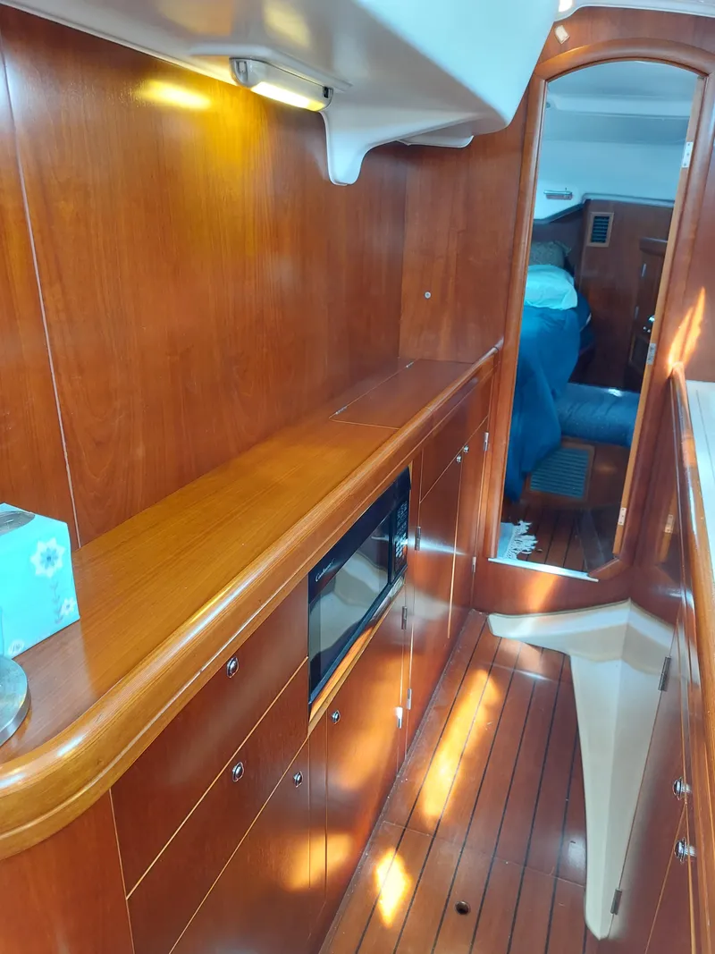 Slide: The Image of Interior of 2002 Beneteau Oceanis 42CC yacht with polished wood finish. - 44