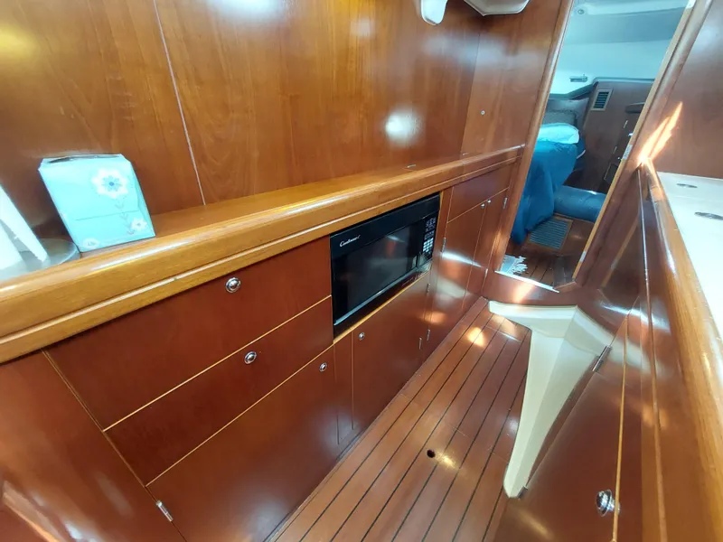Slide: The Image of Interior of 2002 Beneteau Oceanis 42CC yacht with wood paneling and microwave. - 45