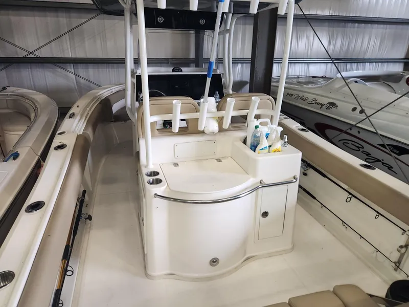 Slide: The Image of 2016 Key West 281 Billistic boat interior with fishing rod holders and storage area. - 10