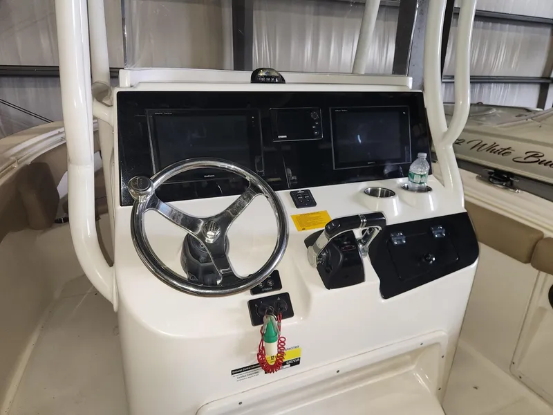 Slide: The Image of 2016 Key West 281 Billistic boat dashboard with steering wheel and electronic displays. - 12