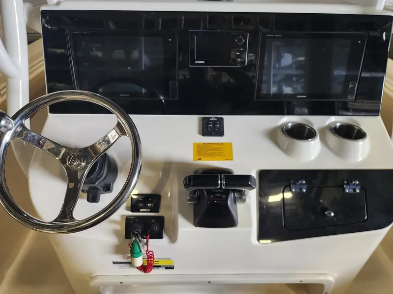 Slide: The Image of 2016 Key West 281 Billistic boat dashboard with steering wheel and control panel. - 14
