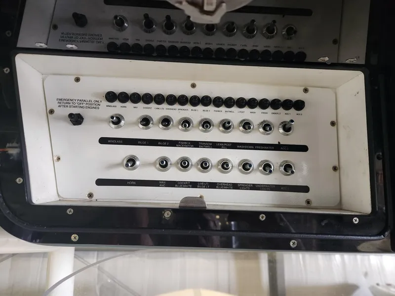 Slide: The Image of Control panel of a 2016 Key West 281 Billistic boat with various switches and dials. - 16