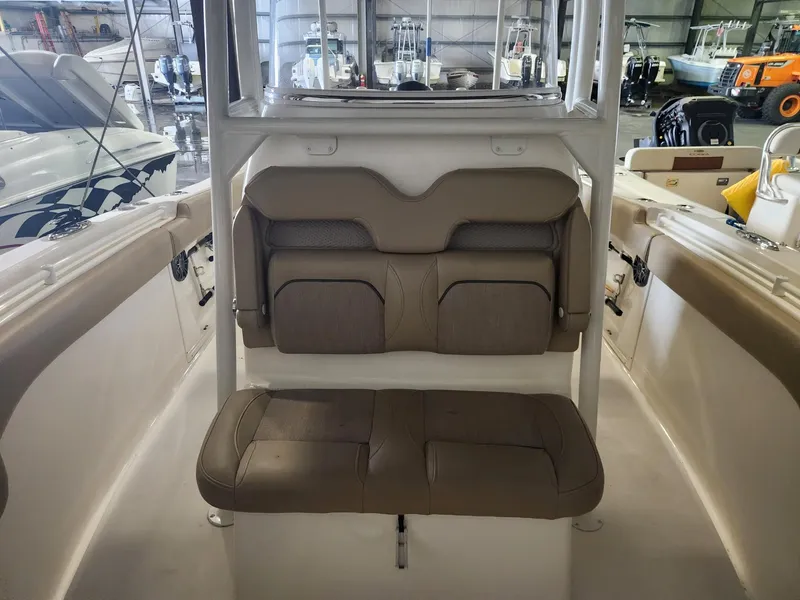 Slide: The Image of 2016 Key West 281 Billistic boat interior with beige seating in a storage facility. - 19