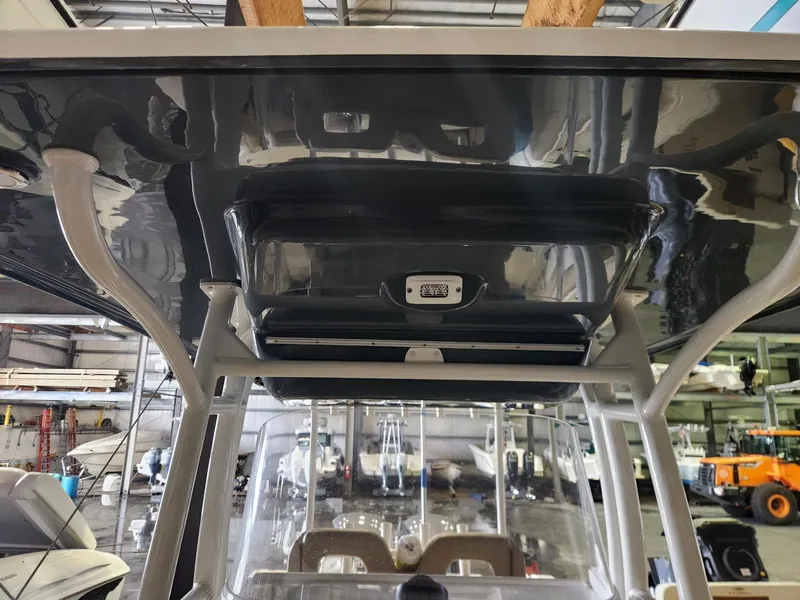 Slide: The Image of 2016 Key West 281 Billistic boat interior, featuring a sleek overhead console in a storage facility. - 21